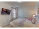 Comfortable bedroom featuring a television, and a window with natural light at 7705 Alder Forest St, Las Vegas, NV 89113