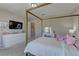 Spacious bedroom has neutral walls, plush carpet, and a bed with bright decor at 7705 Alder Forest St, Las Vegas, NV 89113