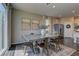 Dining area features a modern table, a sliding glass door to the patio, and neutral paint at 7705 Alder Forest St, Las Vegas, NV 89113