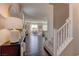 Stylish entryway with hardwood floors, a staircase, and a view into the living room at 7705 Alder Forest St, Las Vegas, NV 89113