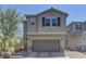 Charming two-story home featuring a two-car garage and brick-paved driveway at 7705 Alder Forest St, Las Vegas, NV 89113