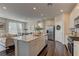 Modern kitchen with an island, stainless steel appliances and a view into the living area at 7705 Alder Forest St, Las Vegas, NV 89113