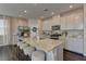 Bright kitchen features granite countertops, stainless appliances, a large island, and hardwood floors at 7705 Alder Forest St, Las Vegas, NV 89113