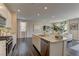 Bright kitchen features granite countertops, stainless appliances, an island, and dark hardwood floors at 7705 Alder Forest St, Las Vegas, NV 89113