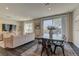 Living room features a dining table, large windows, modern decor, and an open-concept design at 7705 Alder Forest St, Las Vegas, NV 89113