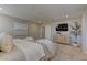 Bright main bedroom features neutral carpet, a TV, and stylish furniture at 7705 Alder Forest St, Las Vegas, NV 89113