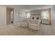 Bright main bedroom features neutral carpet, a window with natural light, and stylish furniture at 7705 Alder Forest St, Las Vegas, NV 89113