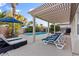 Inviting backyard oasis with a sparkling pool, lounge chairs, and a shaded pergola perfect for relaxation at 8623 Kennedy Heights Ct, Las Vegas, NV 89131