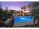 Relaxing backyard oasis featuring a sparkling pool, shaded patio, and lush tropical landscaping at 8623 Kennedy Heights Ct, Las Vegas, NV 89131