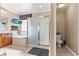 Bright primary bathroom with frosted glass shower, soaking tub, and wood cabinets at 8623 Kennedy Heights Ct, Las Vegas, NV 89131