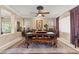 Bright and airy dining room featuring a rustic wooden table and views to other living spaces at 8623 Kennedy Heights Ct, Las Vegas, NV 89131