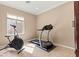 This exercise room features tile floors, crown molding, and fitness equipment including a treadmill and stationary bike at 8623 Kennedy Heights Ct, Las Vegas, NV 89131