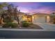 Charming home with a well-manicured front yard, mature trees, a neutral color scheme, and a three-car garage at 8623 Kennedy Heights Ct, Las Vegas, NV 89131