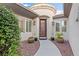 Inviting front entrance with decorative pots, manicured bushes, and a stylish front door at 8623 Kennedy Heights Ct, Las Vegas, NV 89131