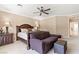 Neutral colored main bedroom featuring, carpet floors, ceiling fan, sofa and accent furniture at 8623 Kennedy Heights Ct, Las Vegas, NV 89131