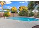 Relaxing pool area surrounded by tropical palm trees and shaded seating perfect for summer days at 8623 Kennedy Heights Ct, Las Vegas, NV 89131