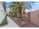 Serene side yard with stone features and rock landscaping for easy maintenance and desert flair at 8623 Kennedy Heights Ct, Las Vegas, NV 89131