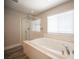 Bright bathroom featuring a large soaking tub and a glass-enclosed shower at 9314 Hopcroft Ave, Las Vegas, NV 89178