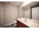 Bathroom with modern fixtures, a sleek vanity, and a neutral color scheme at 9314 Hopcroft Ave, Las Vegas, NV 89178