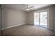 Cozy bedroom with sliding door access to a small backyard patio for outdoor relaxation at 9314 Hopcroft Ave, Las Vegas, NV 89178