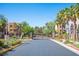 Gated community entrance with lush landscaping and a speed limit sign of 25 at 9314 Hopcroft Ave, Las Vegas, NV 89178