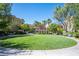 Well-manicured community green with lush landscaping, mature trees, and walking paths at 9314 Hopcroft Ave, Las Vegas, NV 89178