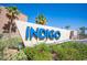 Entrance sign for the Indigo community featuring well kept landscaping with palm trees at 9314 Hopcroft Ave, Las Vegas, NV 89178