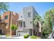 Contemporary two-story home featuring stucco siding, a balcony, and a well-manicured front yard at 9314 Hopcroft Ave, Las Vegas, NV 89178