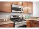 Close-up of a modern kitchen featuring stainless steel microwave, oven, and granite countertops at 9314 Hopcroft Ave, Las Vegas, NV 89178