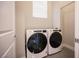 Bright laundry room features modern appliances and a window for natural light at 9314 Hopcroft Ave, Las Vegas, NV 89178