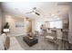 Bright living room featuring an open floor plan, ceiling fan, and bar seating area at 9314 Hopcroft Ave, Las Vegas, NV 89178