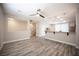 Open-concept living room with hardwood floors, ceiling fan, and stylish lighting fixtures at 9314 Hopcroft Ave, Las Vegas, NV 89178