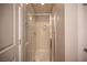 Walk-in shower with glass doors and a neutral color palette at 9314 Hopcroft Ave, Las Vegas, NV 89178