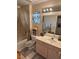 Well-lit bathroom featuring a shower-tub combo, a vanity with sink and decorative curtains at 9505 Quail Ridge Dr, Las Vegas, NV 89134
