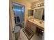 Bright bathroom featuring a walk-in shower and a vanity with a built-in make up table at 9505 Quail Ridge Dr, Las Vegas, NV 89134