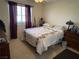 Cozy bedroom featuring natural light and a floral-patterned bedspread at 9505 Quail Ridge Dr, Las Vegas, NV 89134