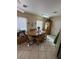 Bright dining area with tiled flooring, a wood table, and plenty of seating at 9505 Quail Ridge Dr, Las Vegas, NV 89134