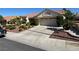 Charming single-story home featuring a tile roof, desert landscaping, and an attached two-car garage at 9505 Quail Ridge Dr, Las Vegas, NV 89134