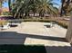 Spacious patio area with outdoor seating and beautiful palm trees at 9505 Quail Ridge Dr, Las Vegas, NV 89134