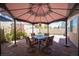 Patio area with seating, pavers, and an umbrella, providing a pleasant outdoor space at 9632 Spanish Steps Ln, Las Vegas, NV 89117