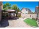 Exterior patio featuring pavers, outdoor seating, a gazebo, lush greenery, and block wall at 9632 Spanish Steps Ln, Las Vegas, NV 89117