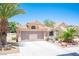 Attractive single-story home featuring desert landscaping, mature palm trees, and a two-car garage at 9632 Spanish Steps Ln, Las Vegas, NV 89117