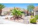 Landscaped front yard featuring decorative rock, mature palm trees, and concrete walkway at 9632 Spanish Steps Ln, Las Vegas, NV 89117
