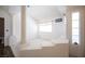 Bright loft area featuring carpet, decorative columns, and natural light from windows at 9632 Spanish Steps Ln, Las Vegas, NV 89117