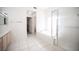 Spacious bathroom with a soaking tub, glass-enclosed shower, and tiled floors at 9728 Drumcannon Ave, Las Vegas, NV 89129