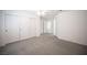 Spacious bedroom with three closets, gray carpet, white walls, and a ceiling fan at 9728 Drumcannon Ave, Las Vegas, NV 89129