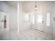 Bright entrance with tile flooring, white walls, and a decorative front door with side windows at 9728 Drumcannon Ave, Las Vegas, NV 89129