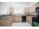 Well-equipped kitchen featuring stainless steel appliances, granite countertops, and custom cabinets at 9728 Drumcannon Ave, Las Vegas, NV 89129
