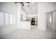 Bright living area with tile floors, ceiling fan, kitchen view, and shuttered windows at 9728 Drumcannon Ave, Las Vegas, NV 89129