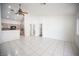 Bright living area with tile floors, ceiling fan, and an open view of the kitchen at 9728 Drumcannon Ave, Las Vegas, NV 89129